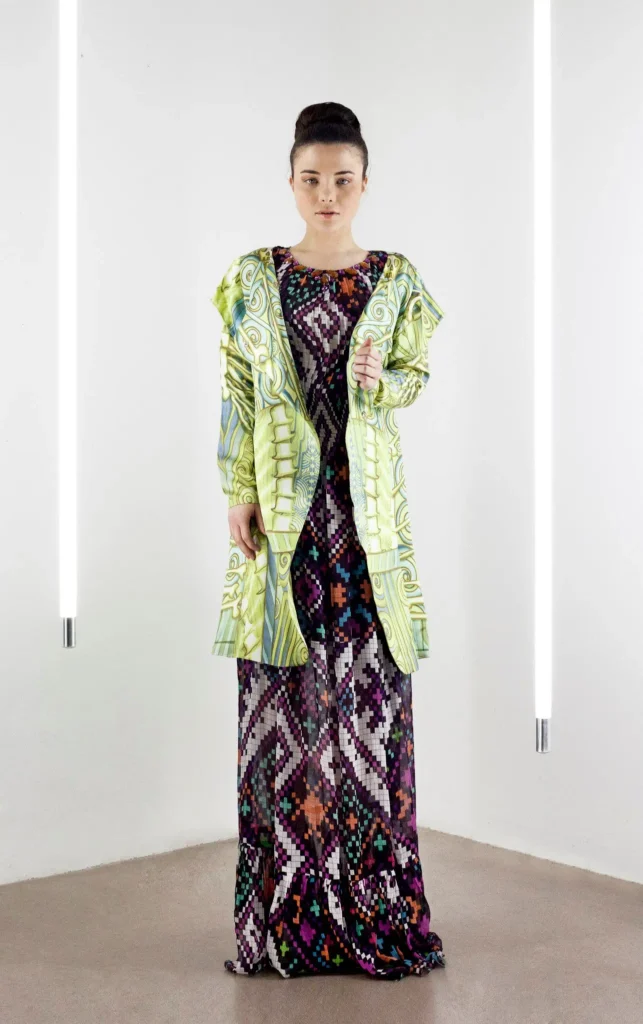 Model wearing a ceramic print kaftan in silk crinkle chiffon, paired with a green shawl collar jacket.